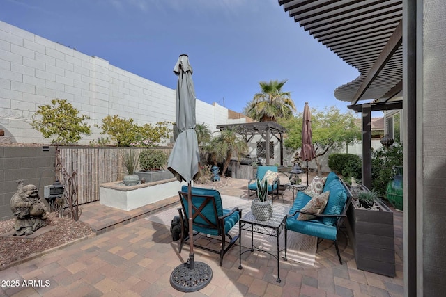 view of patio featuring a fenced backyard and a pergola