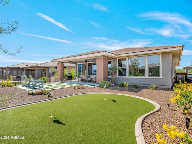 back of property featuring ceiling fan and a patio area