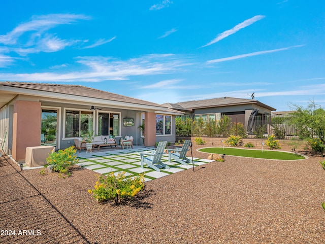 back of house with ceiling fan, an outdoor hangout area, and a patio