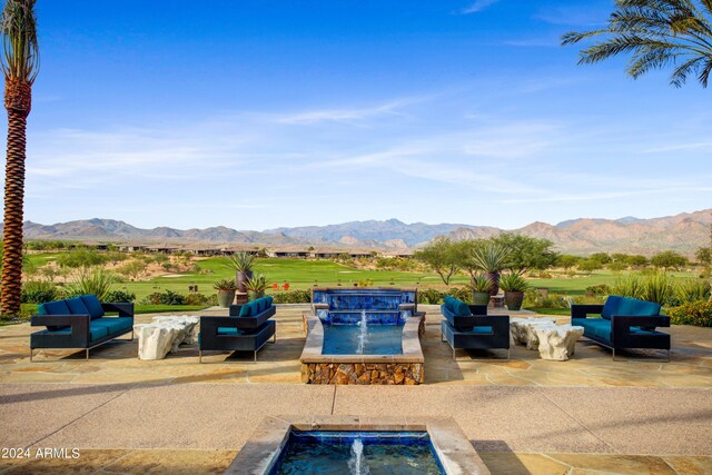 view of pool with outdoor lounge area, a mountain view, a patio area, and an in ground hot tub