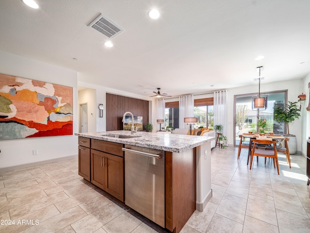 kitchen with dishwasher, a center island with sink, sink, hanging light fixtures, and ceiling fan