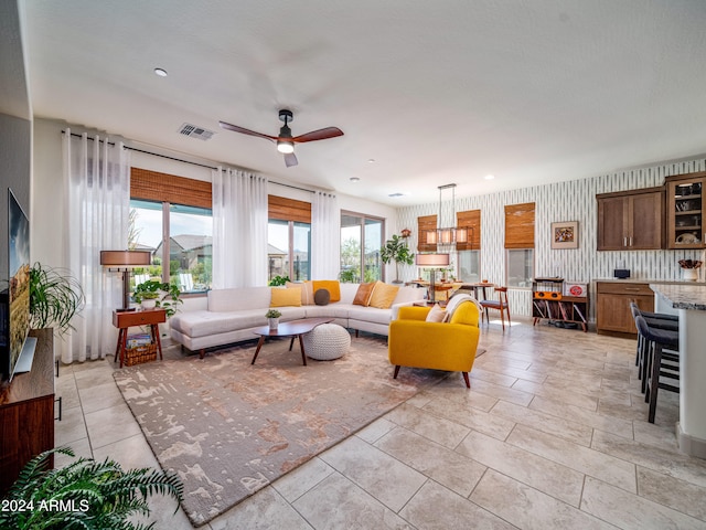 living room with ceiling fan and light tile patterned floors