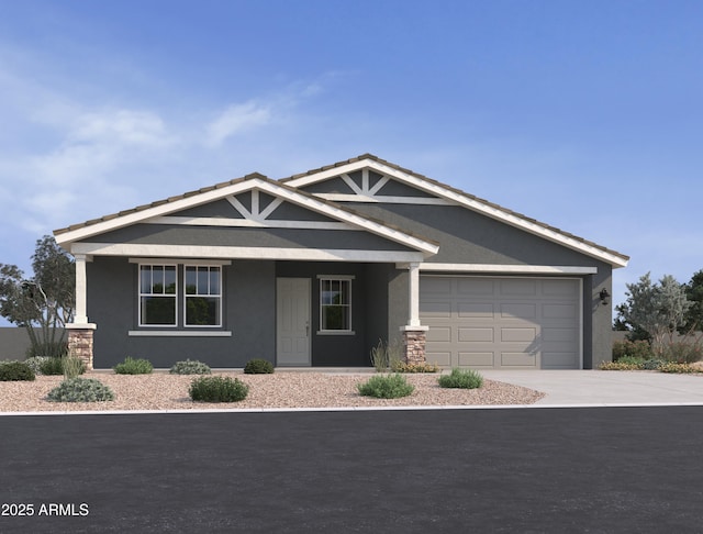 view of front of property with stucco siding, a garage, driveway, and a tile roof