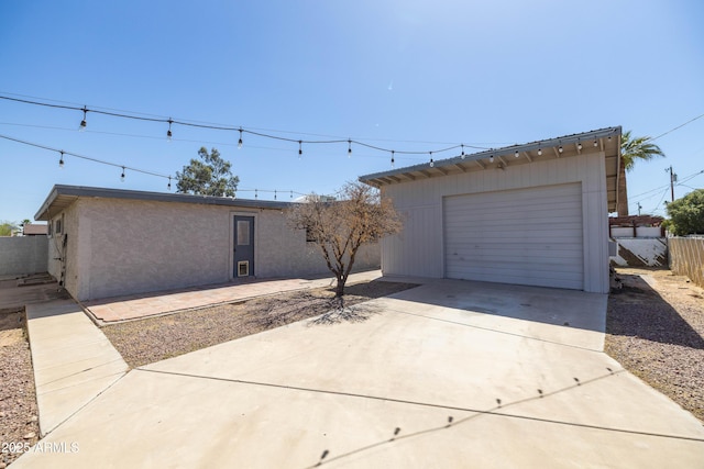 2346 E Sylvia St, Phoenix, AZ 85022 - view of front facade featuring concrete driveway, fence, a detached garage, an outdoor structure, and stucco siding