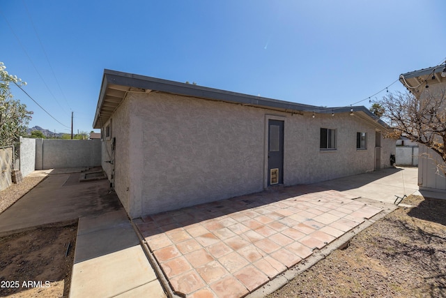 2346 E Sylvia St, Phoenix, AZ 85022 - back of property with stucco siding, a fenced backyard, and a patio area