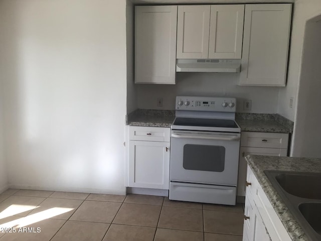 kitchen featuring white cabinetry, sink, light tile patterned floors, and electric range