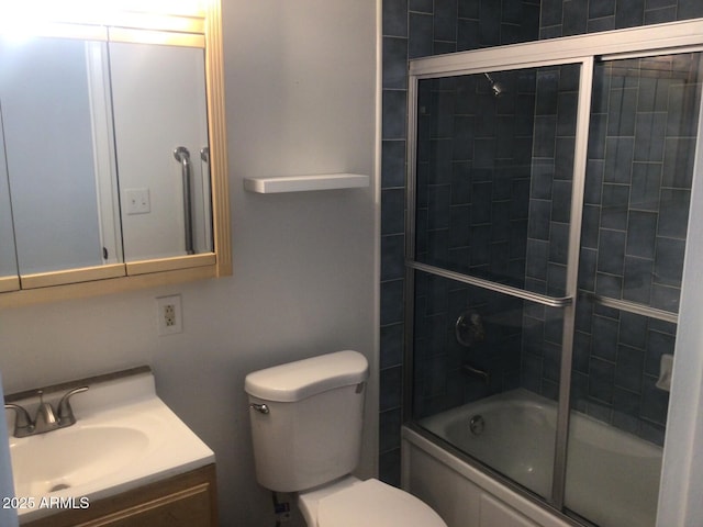 full bathroom featuring enclosed tub / shower combo, vanity, and toilet