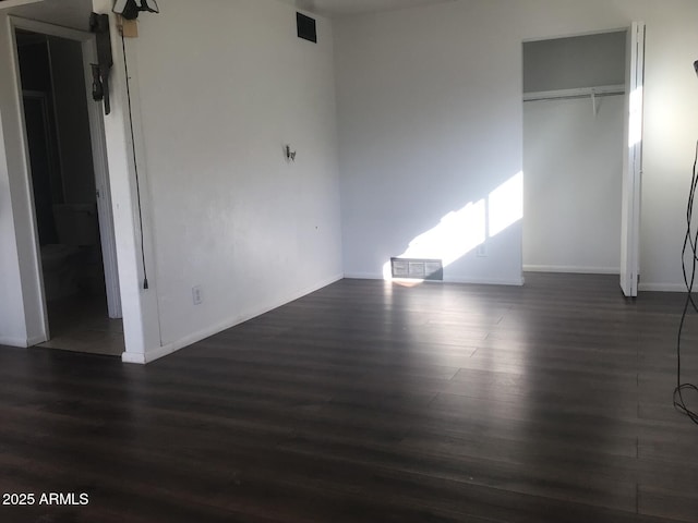 unfurnished bedroom featuring dark hardwood / wood-style floors and a closet