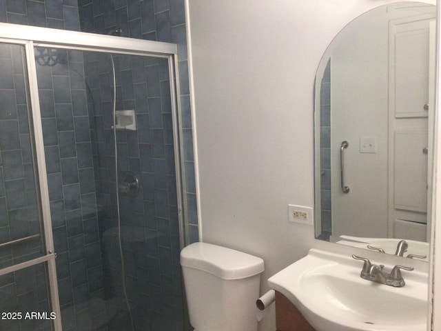 bathroom with walk in shower, vanity, and toilet