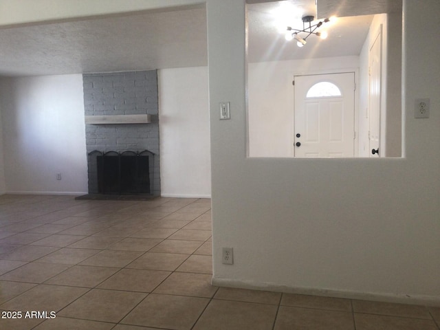 tiled entrance foyer with a brick fireplace