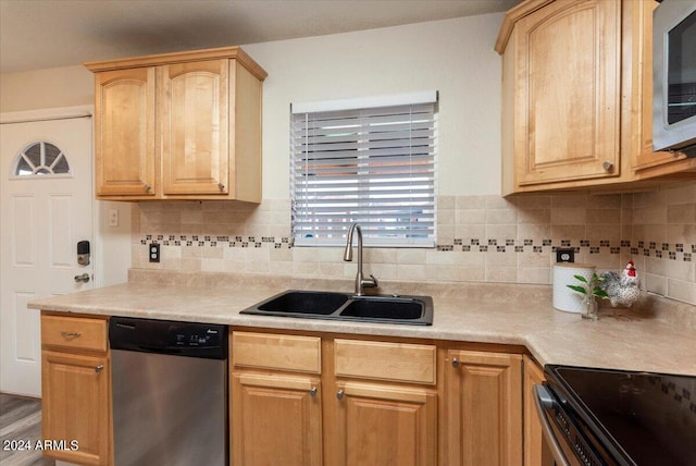 kitchen featuring light brown cabinetry, sink, decorative backsplash, and stainless steel appliances