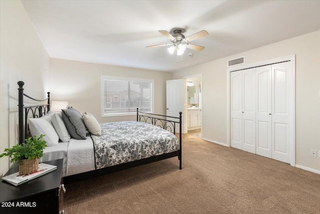 bedroom featuring ensuite bathroom, carpet flooring, ceiling fan, and a closet