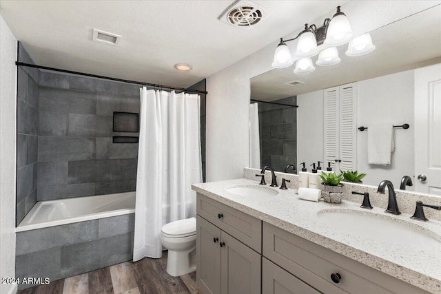 full bathroom featuring hardwood / wood-style flooring, vanity, toilet, and shower / bath combo with shower curtain