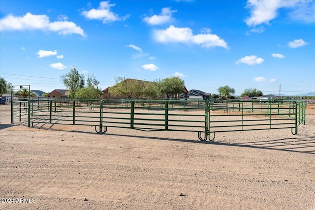 view of horse barn featuring a rural view