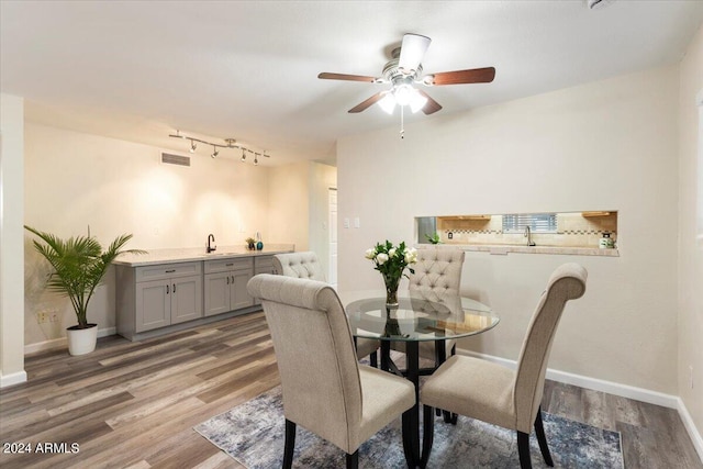 dining room with hardwood / wood-style flooring and sink