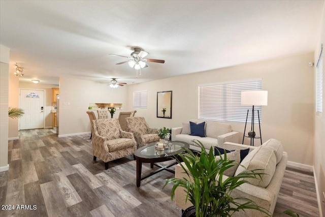 living room featuring ceiling fan and dark hardwood / wood-style flooring