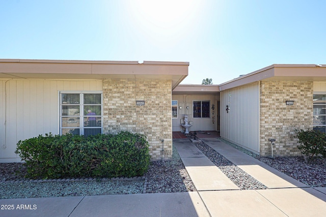 property entrance with brick siding