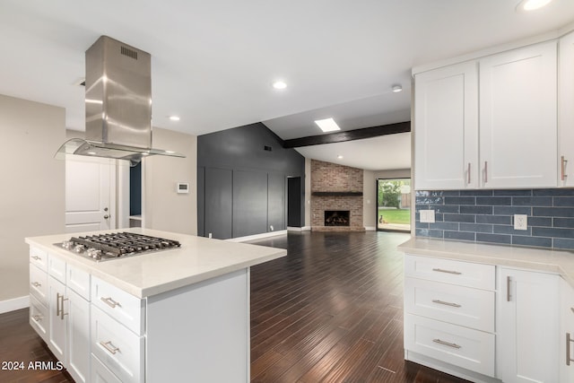 kitchen with stainless steel gas stovetop, dark hardwood / wood-style flooring, and white cabinetry