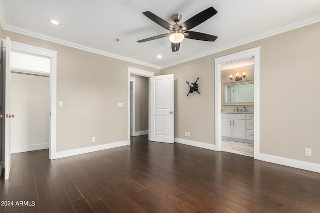 unfurnished bedroom with ceiling fan, connected bathroom, dark wood-type flooring, and crown molding