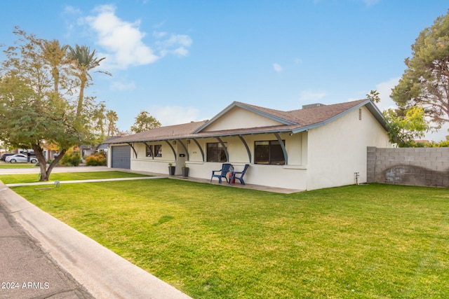 single story home featuring a front lawn and a garage