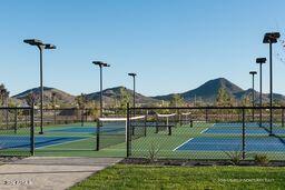 view of sport court featuring a mountain view and fence