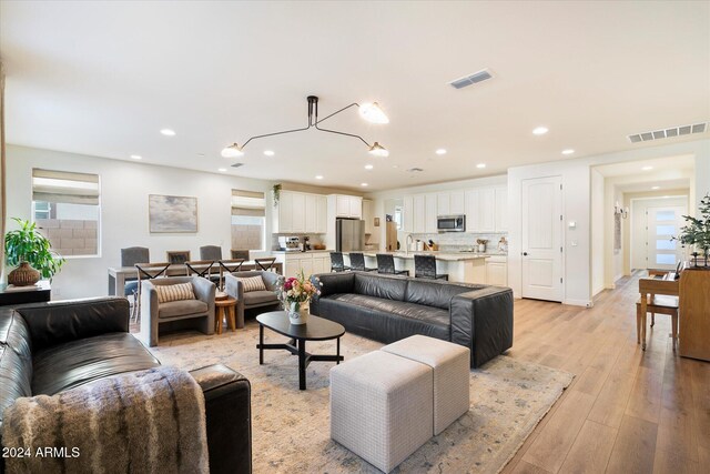 living room with plenty of natural light and light wood-type flooring