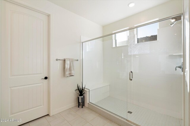 bathroom featuring tile patterned floors and a shower with door