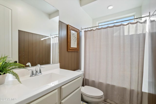 full bathroom with shower / tub combo, vanity, and toilet