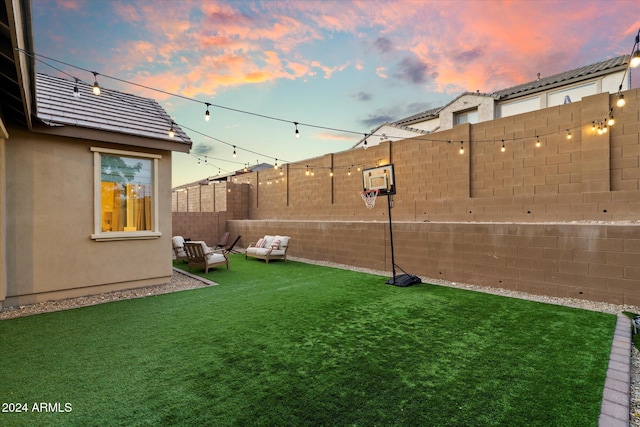 yard at dusk with outdoor lounge area