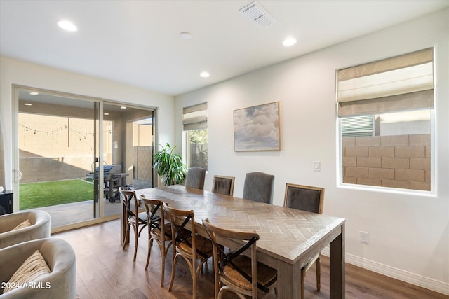 dining room with a wealth of natural light and hardwood / wood-style flooring