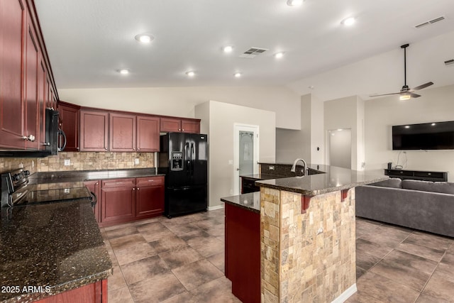 25212 W Maldonado Dr, Buckeye, AZ 85326 - kitchen featuring visible vents, black appliances, reddish brown cabinets, lofted ceiling, and open floor plan