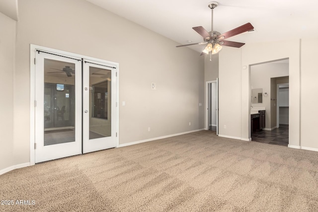 25212 W Maldonado Dr, Buckeye, AZ 85326 - unfurnished bedroom with access to exterior, vaulted ceiling, carpet floors, baseboards, and connected bathroom
