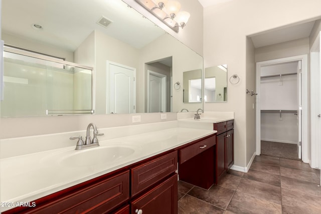 25212 W Maldonado Dr, Buckeye, AZ 85326 - full bath featuring visible vents, tile patterned flooring, vanity, a walk in closet, and a stall shower