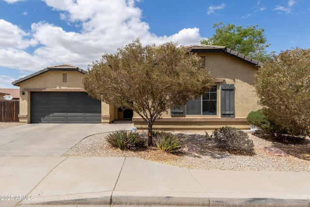 25212 W Maldonado Dr, Buckeye, AZ 85326 - obstructed view of property featuring an attached garage, driveway, a tile roof, and stucco siding