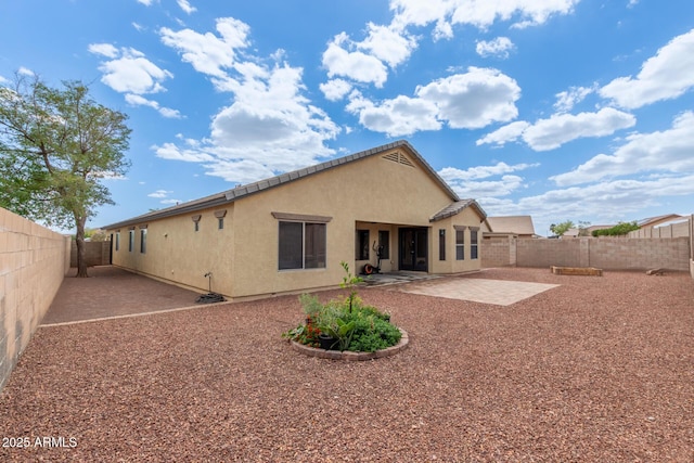 25212 W Maldonado Dr, Buckeye, AZ 85326 - back of property featuring a fenced backyard, a patio area, and stucco siding