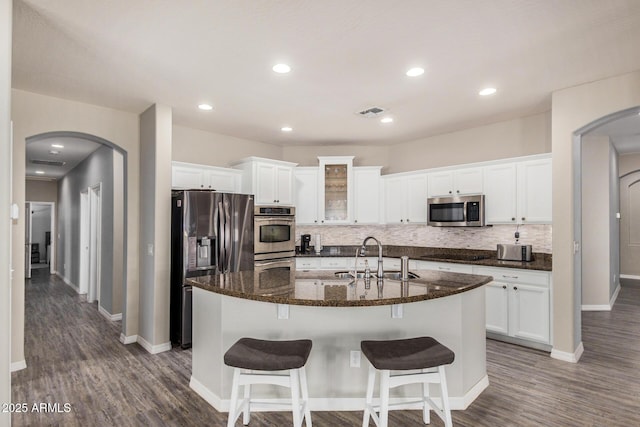 kitchen featuring white cabinetry, an island with sink, stainless steel appliances, and sink