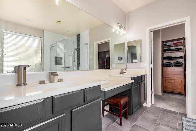 bathroom featuring a shower with door and vanity