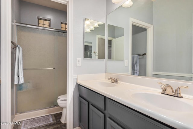 bathroom featuring walk in shower, vanity, and toilet