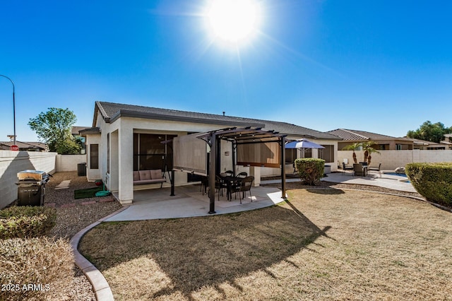 rear view of house with a pergola, a patio area, and a lawn