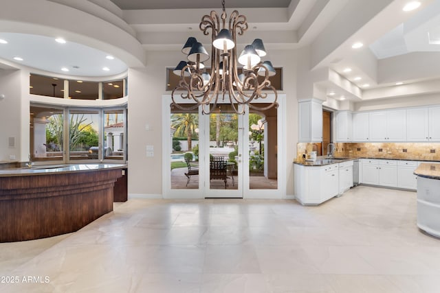 kitchen featuring white cabinetry, a chandelier, tasteful backsplash, recessed lighting, and decorative light fixtures