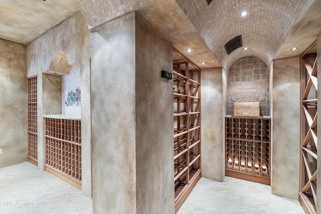 wine area featuring vaulted ceiling and recessed lighting