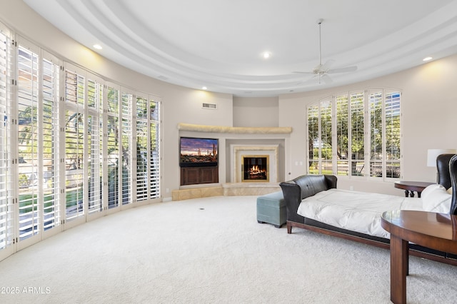 living area with carpet, recessed lighting, plenty of natural light, ceiling fan, and a glass covered fireplace