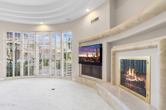 unfurnished living room featuring recessed lighting, a premium fireplace, and carpet floors