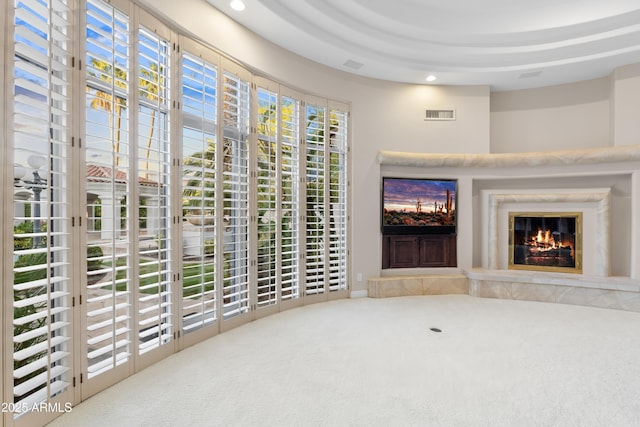 unfurnished living room featuring a fireplace, carpet flooring, and recessed lighting