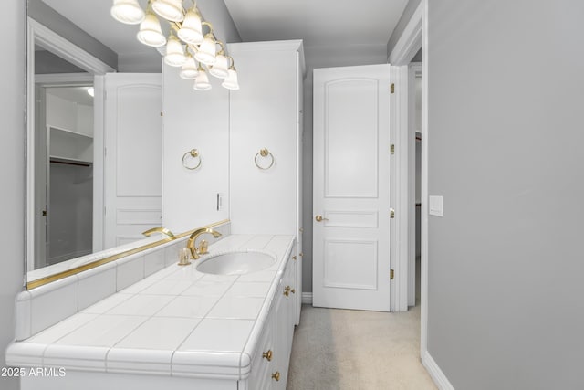 bathroom with vanity and baseboards