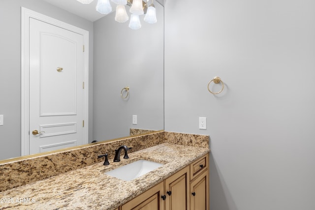 bathroom featuring vanity and a chandelier