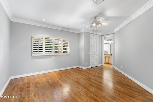 unfurnished bedroom with wood finished floors, ornamental molding, baseboards, ensuite bathroom, and recessed lighting