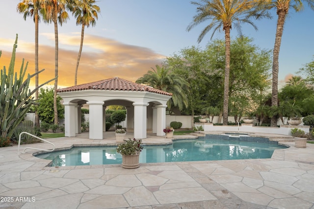 view of swimming pool with a gazebo, a patio, and an in-ground hot tub