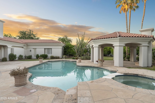 view of pool featuring a patio area, a gazebo, and a pool with connected hot tub
