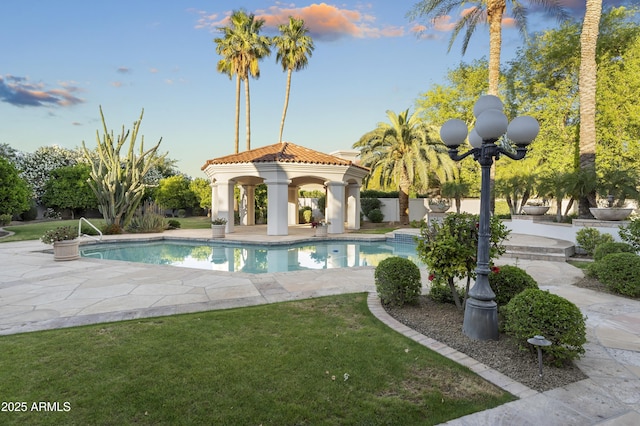swimming pool featuring a gazebo, a patio, and a lawn